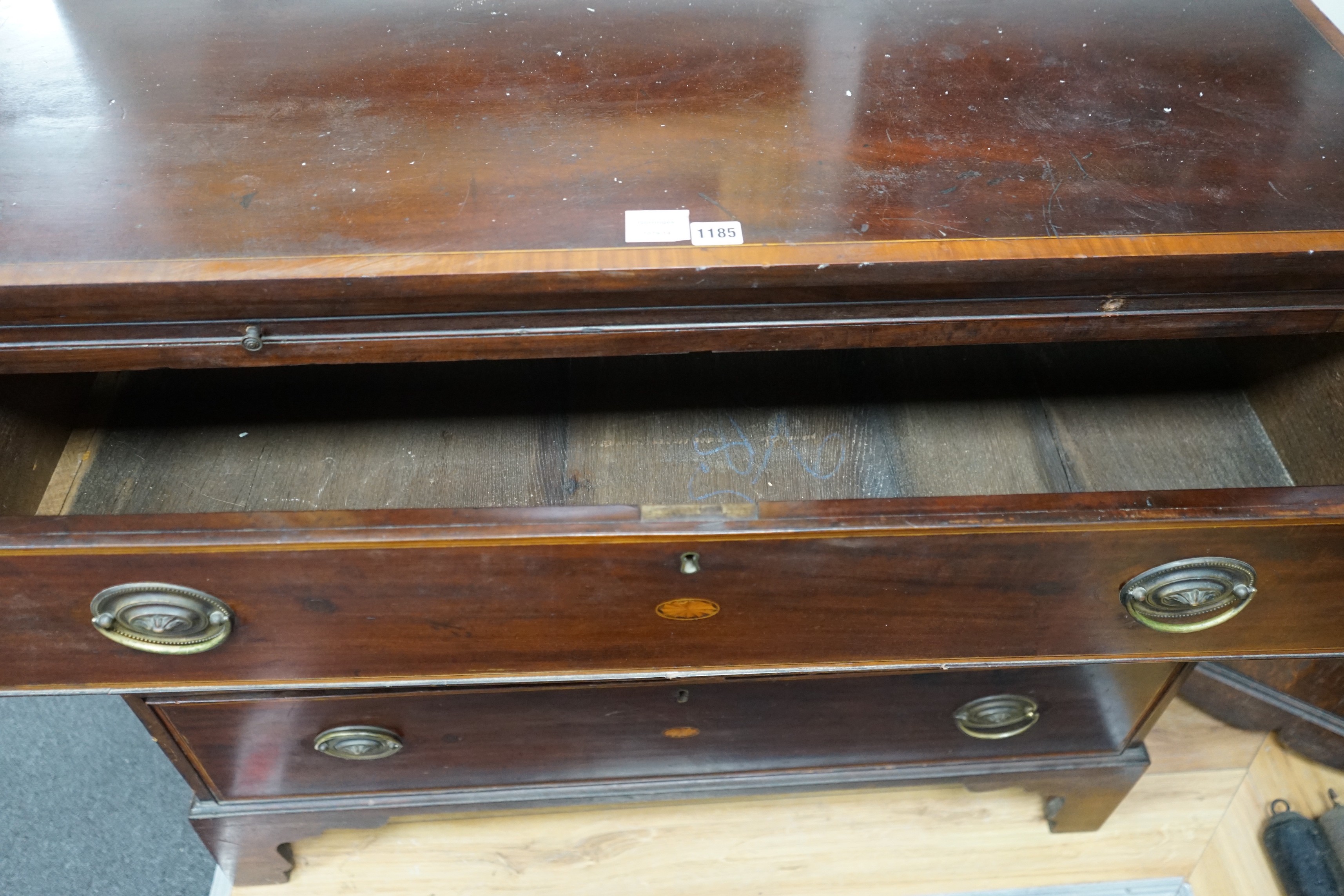 A George III inlaid mahogany three drawer chest with brushing slide, width 109cm, depth 52cm, height 74cm